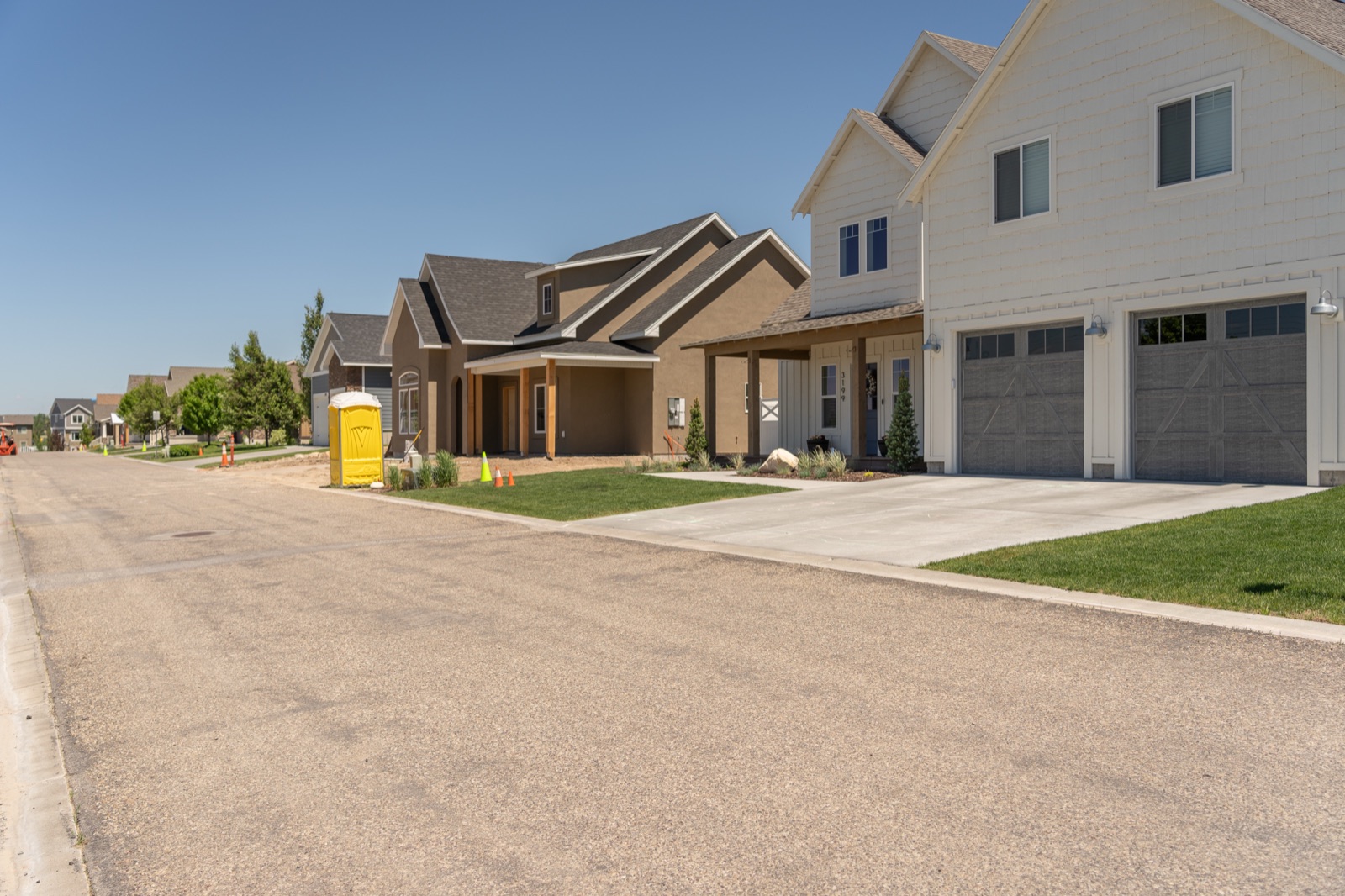 A modern home in Hawks Landing with stone accents and a clean residential street